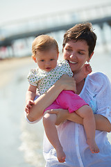 Image showing mom and baby on beach  have fun