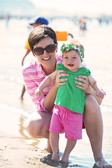 Image showing mom and baby on beach  have fun