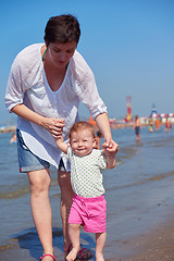 Image showing mom and baby on beach  have fun