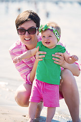 Image showing mom and baby on beach  have fun