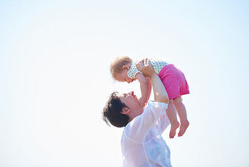 Image showing mom and baby on beach  have fun