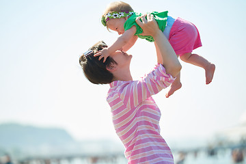 Image showing mom and baby on beach  have fun