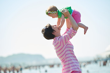 Image showing mom and baby on beach  have fun