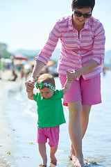 Image showing mom and baby on beach  have fun