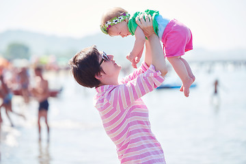 Image showing mom and baby on beach  have fun