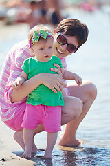 Image showing mom and baby on beach  have fun