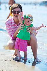 Image showing mom and baby on beach  have fun