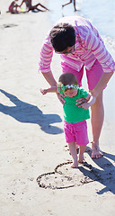 Image showing mom and baby on beach  have fun