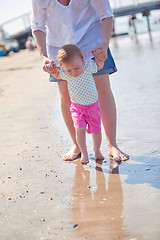 Image showing mom and baby on beach  have fun