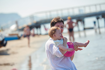 Image showing mom and baby on beach  have fun