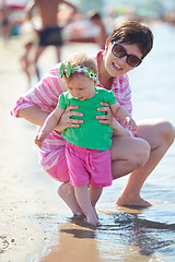 Image showing mom and baby on beach  have fun