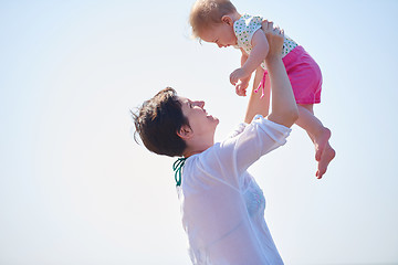 Image showing mom and baby on beach  have fun