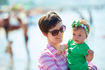 Image showing mom and baby on beach  have fun