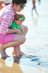 Image showing mom and baby on beach  have fun