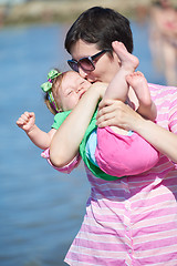 Image showing mom and baby on beach  have fun