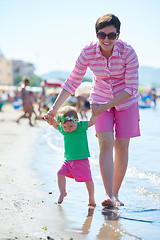 Image showing mom and baby on beach  have fun