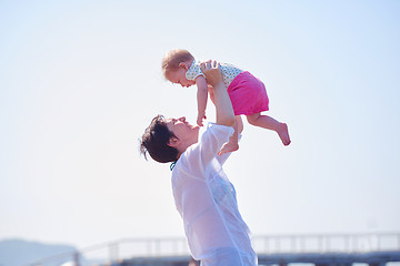 Image showing mom and baby on beach  have fun