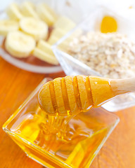 Image showing Honey in the glass bowl on the wooden table