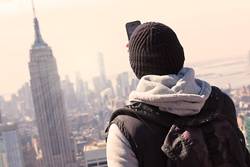 Image showing Tourist taking photo of New York City.