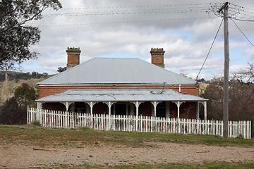 Image showing Landscape scene with abandoned old house picket fence rural coun