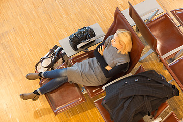 Image showing Tired female traveler waiting for departure.