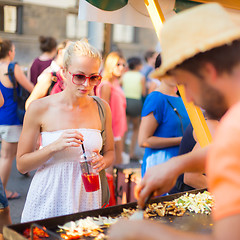 Image showing Woman buying a meal at food market.