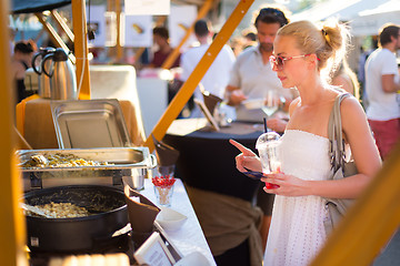 Image showing Woman buying a meal at food market.