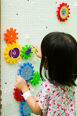 Image showing Chinese girl solving puzzle