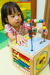 Image showing Chinese girl solving puzzle