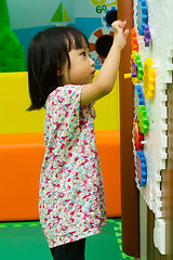 Image showing Chinese girl solving puzzle