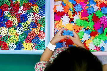 Image showing Chinese girl solving puzzle