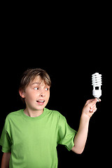 Image showing Child holds a compact fluorescent globe