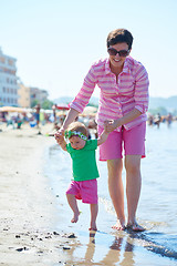 Image showing mom and baby on beach  have fun