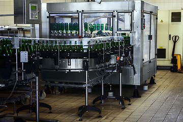 Image showing Many bottles on conveyor belt