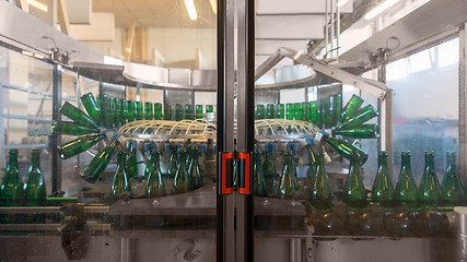 Image showing Bottling machine with many bottles