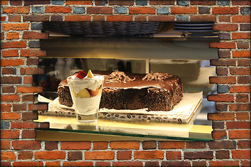 Image showing hole in wall and counter with ice-cream and cakes