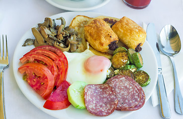 Image showing Sausage and scrambled eggs with owoseni on the plate.