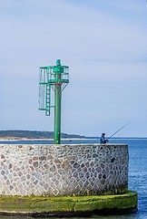 Image showing Fishing man at the entrance of the seaport of Ustka, Poland