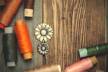 Image showing vintage buttons and old reels of varicolored thread