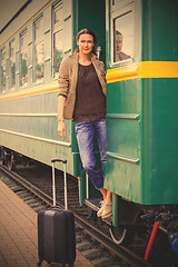 Image showing beautiful adult woman on the steps of the passenger car