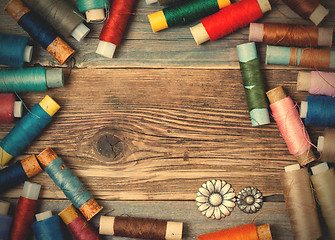 Image showing vintage reels of varicolored thread and old flower buttons