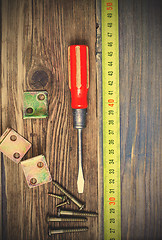 Image showing Vintage screwdriver, screws, angles and measuring tape