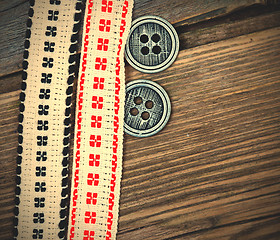 Image showing two vintage tape with embroidered ornaments and old buttons