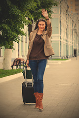 Image showing pretty adult woman traveler with suitcase