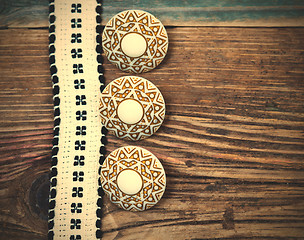 Image showing Vintage ribbon with embroidered pattern and three ancient button