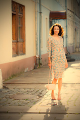 Image showing smiling beautiful woman with a small handbag