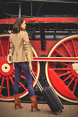 Image showing beautiful adult woman traveler with a suitcase