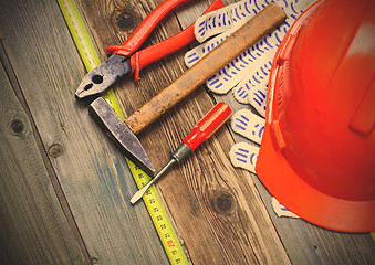 Image showing pliers, hammer, screwdriver, measuring tape, gloves and orange h