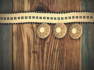 Image showing Vintage tape with embroidered pattern and three ancient buttons