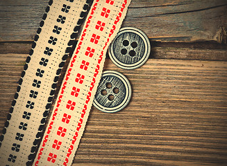 Image showing two old ribbons with embroidered ornaments and vintage buttons